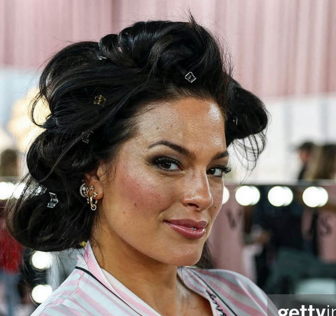 people-Ashley Graham-getting hair done-hair rollers/clips-makeup application-pink striped robe