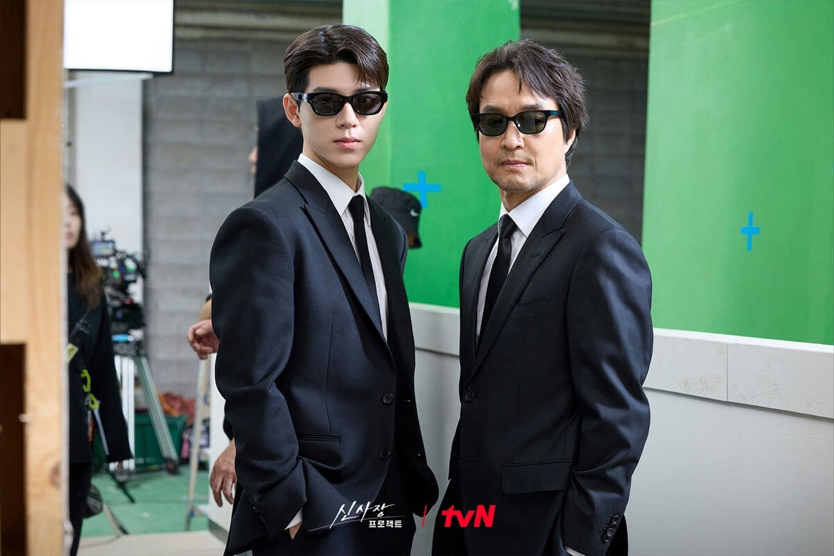 people-two men-A-black suits-B-sunglasses-C-behind the scenes