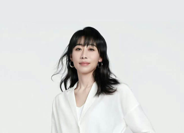 people-woman-black hair-silver hoop earrings-white blouse-minimalist background