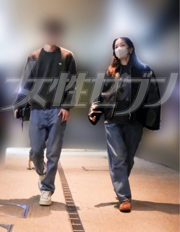 people-two-walking-A-casual-attire-A-face-mask-A-Japanese-text-watermark