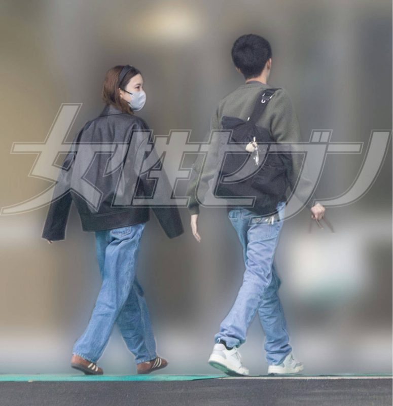 people-two-walking-A-woman-wearing-a-mask-and-leather-jacket-A-man-carrying-a-backpack-A-casual-outfit