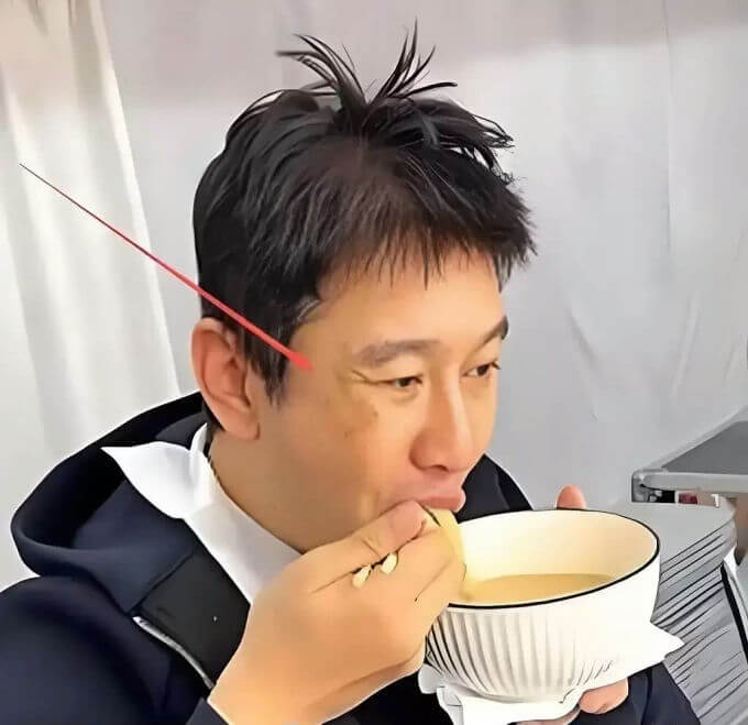 people-Asian man-eating-A-holding bowl-A-wrinkles shown-A-casual attire