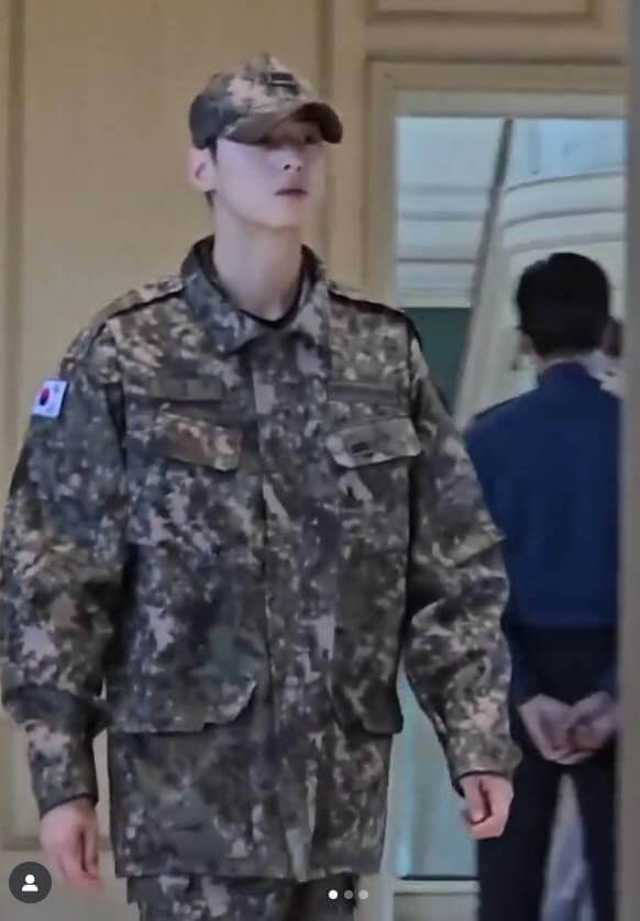 people-One male figure-A-military uniform-A-South Korean flag patch-B-camouflage pattern-C-another person in blue shirt