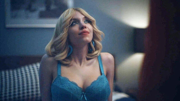 people-1-Sydney Sweeney-A-blonde hair-A-blue lace bra-A-blue hoop earrings-B-looking up