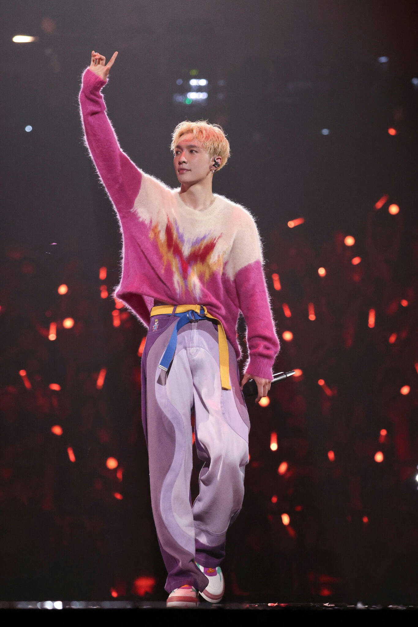 people-Male performer-A-fuzzy pink and white sweater-B-wavy purple pants-C-raising hand