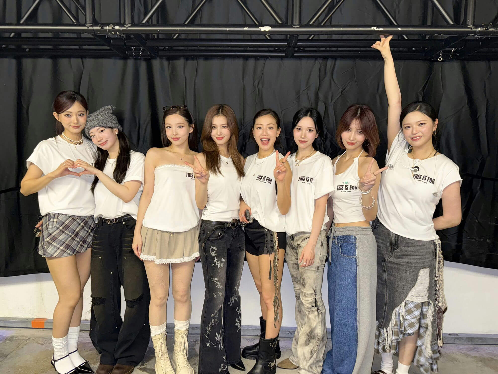 people-9-Korean-girl-group-TWICE-A-all-wearing-white-tops-A-casual-and-stylish-fashion-A-posing-for-a-photo-in-front-of-a-black-backdrop
