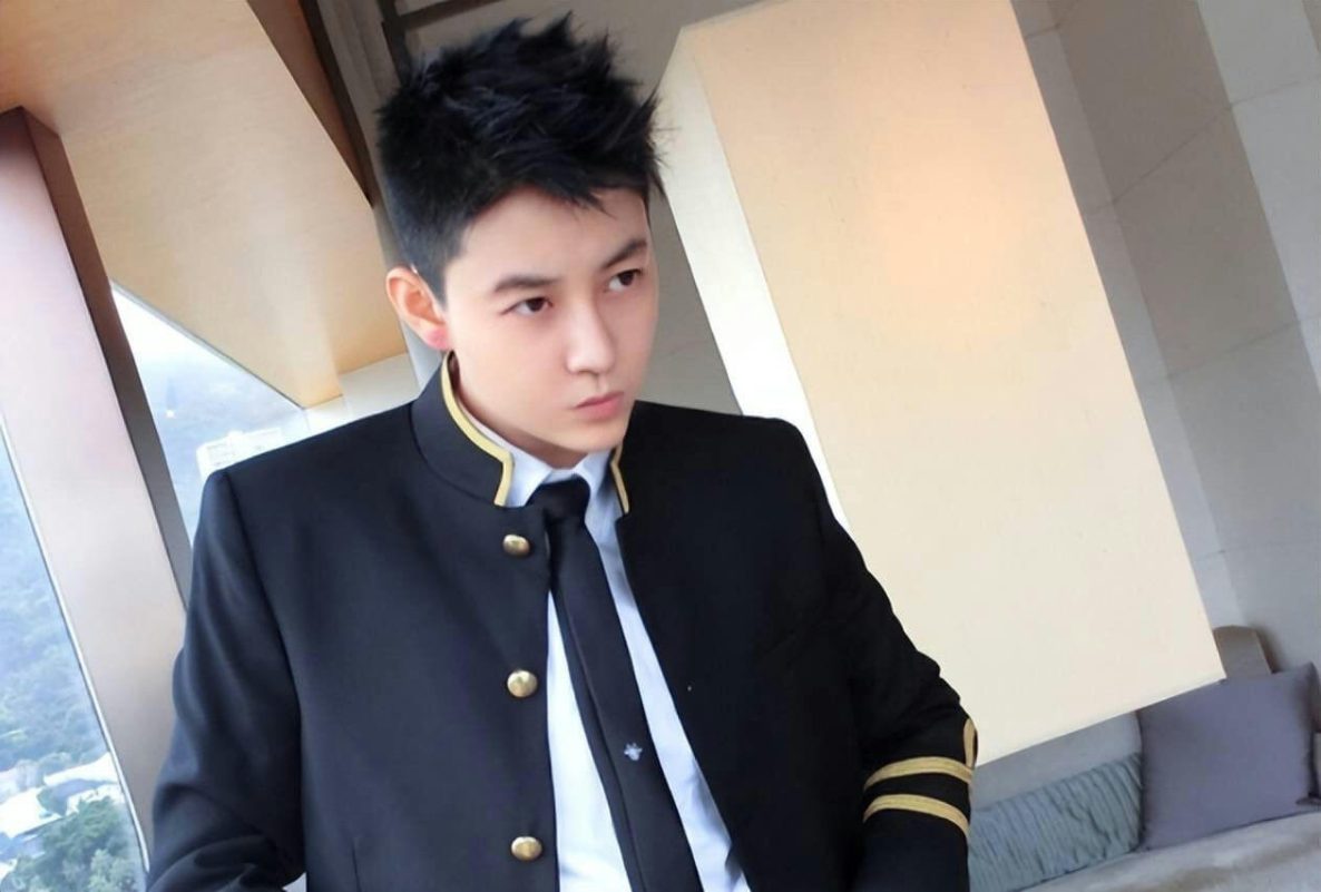 people-young man-A-uniform-A-black jacket-A-gold accents-B-indoor setting-B-looking away-C