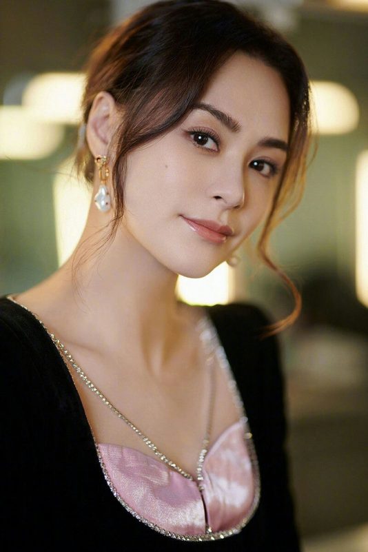 people-woman-A-portrait-A-elegant-A-pearl earrings-A-black dress-A-pink bustier