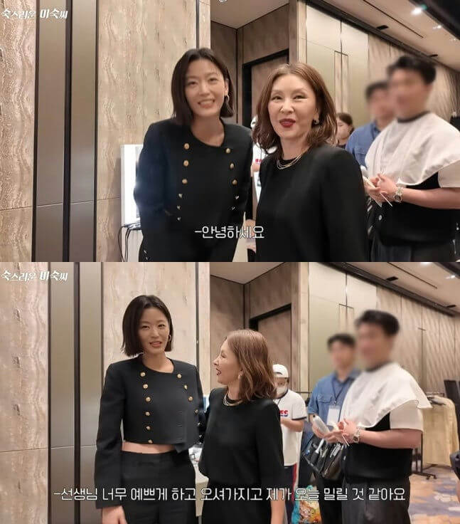 people-two-women-A-smiling-A-black-outfit-B-middle-aged-B-short-hair-C-indoor-setting
