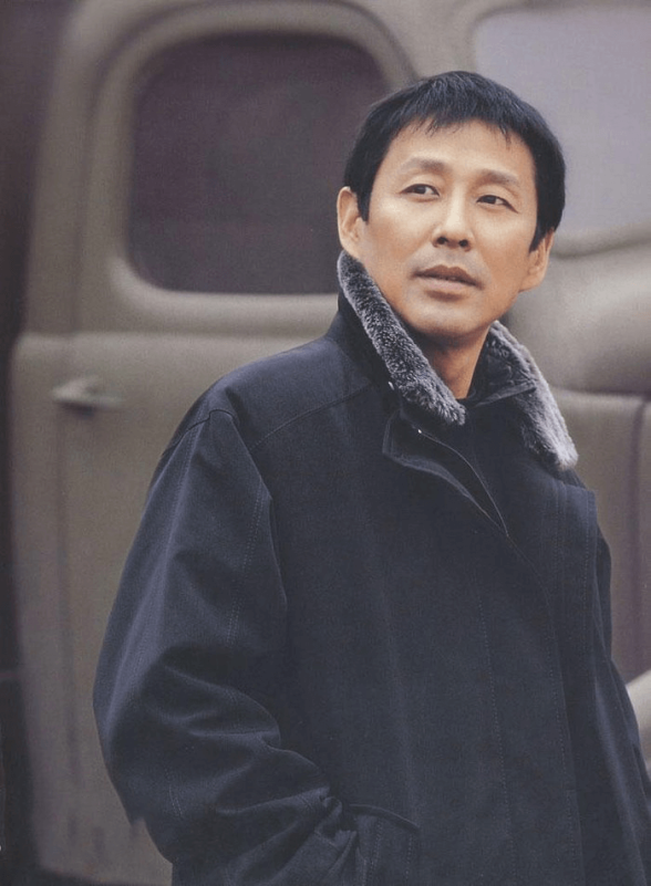 people-1-Asian man-A-actor-A-black coat with fur collar-B-outdoor setting with vehicle-C-looking slightly off-camera