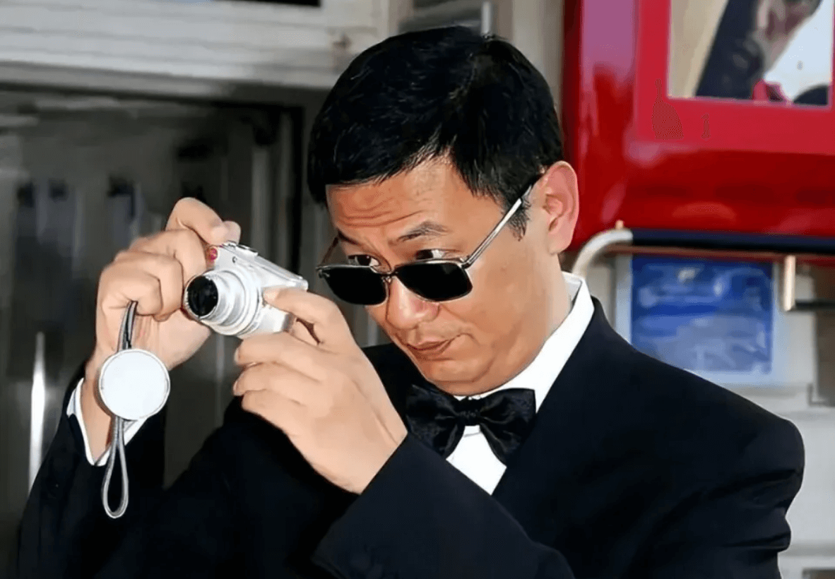people-man-A-black suit-A-bow tie-A-sunglasses-A-silver digital camera-A-taking photo