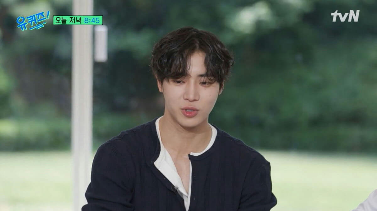 people-man-dark hair-dark blue shirt-white undershirt-tvN logo-Korean text