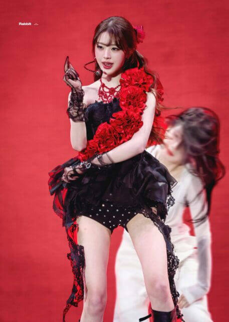 people-1-female performer-A-black and red flamenco-inspired outfit-B-red ruffled shawl/boa-C-stage performance