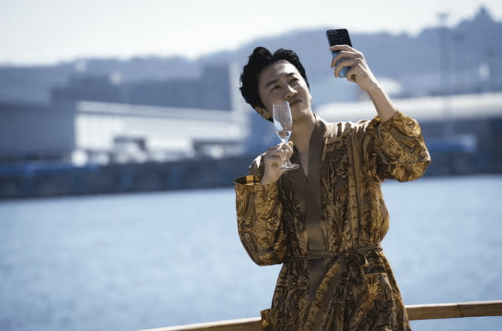 people-Man-A-taking-selfie-B-holding-champagne-glass-C-wearing-gold-robe