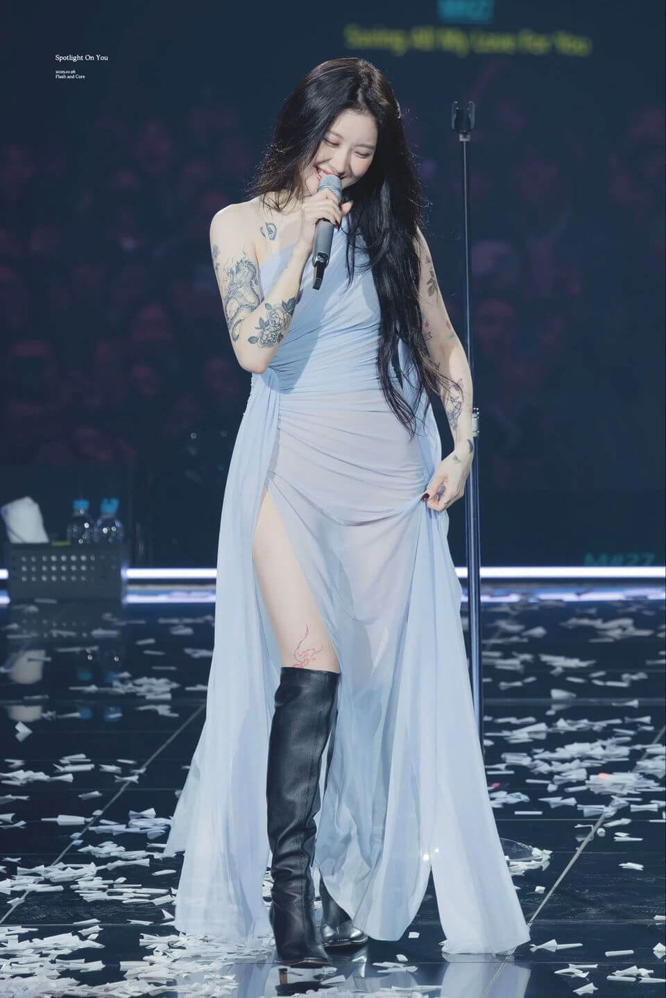 people-woman-singing-A-light blue dress-A-black thigh-high boots-A-tattoos