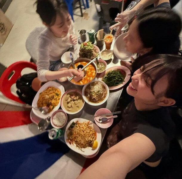 people-3-dining-A-Thai food-A-selfie-A-table full of dishes