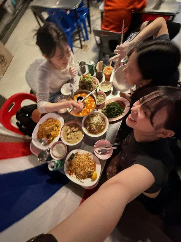 people-3-dining-A-Thai food-A-selfie-A-table full of dishes