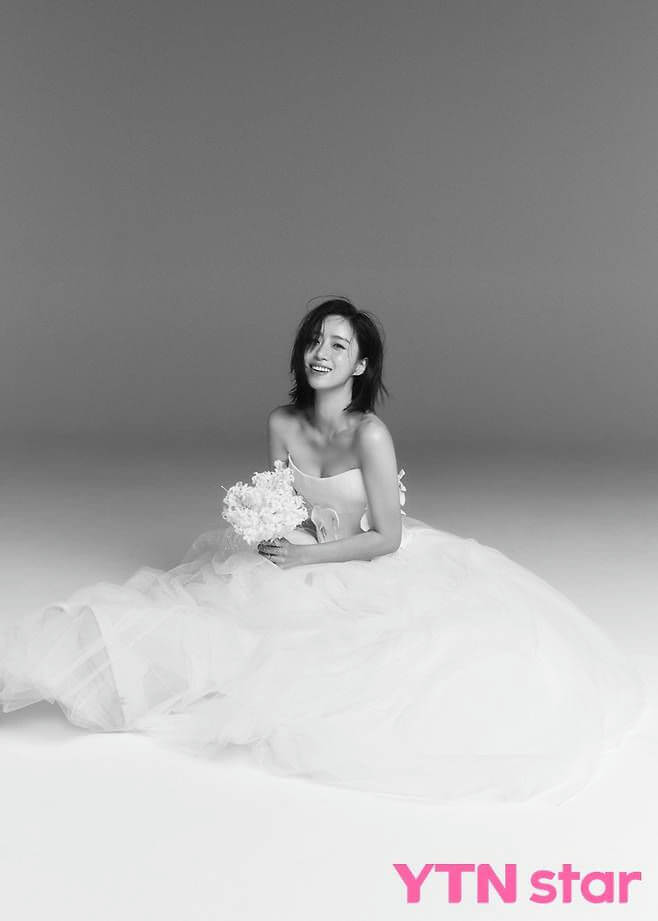 people-A-woman-A-smiling-A-wedding dress-A-holding bouquet-A-black and white