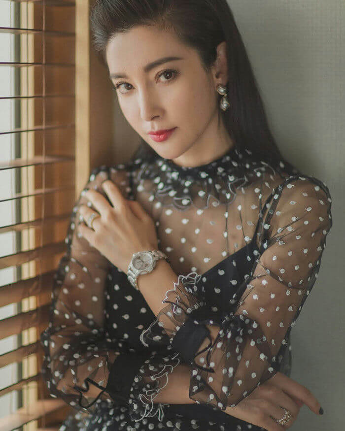 people-Woman-A-elegant-A-polka dot sheer blouse-A-jewelry-A-indoor portrait