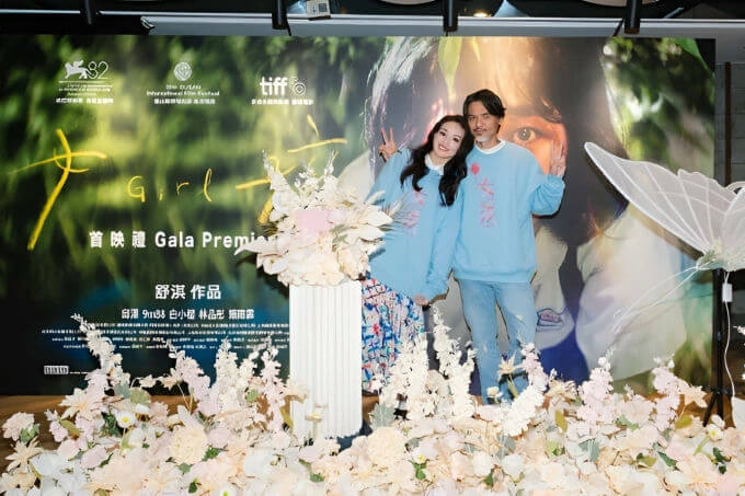 people-two-couple-posing-A-flower-decoration-A-movie-poster-A-light-blue-sweatshirts-B-peace-signs-C