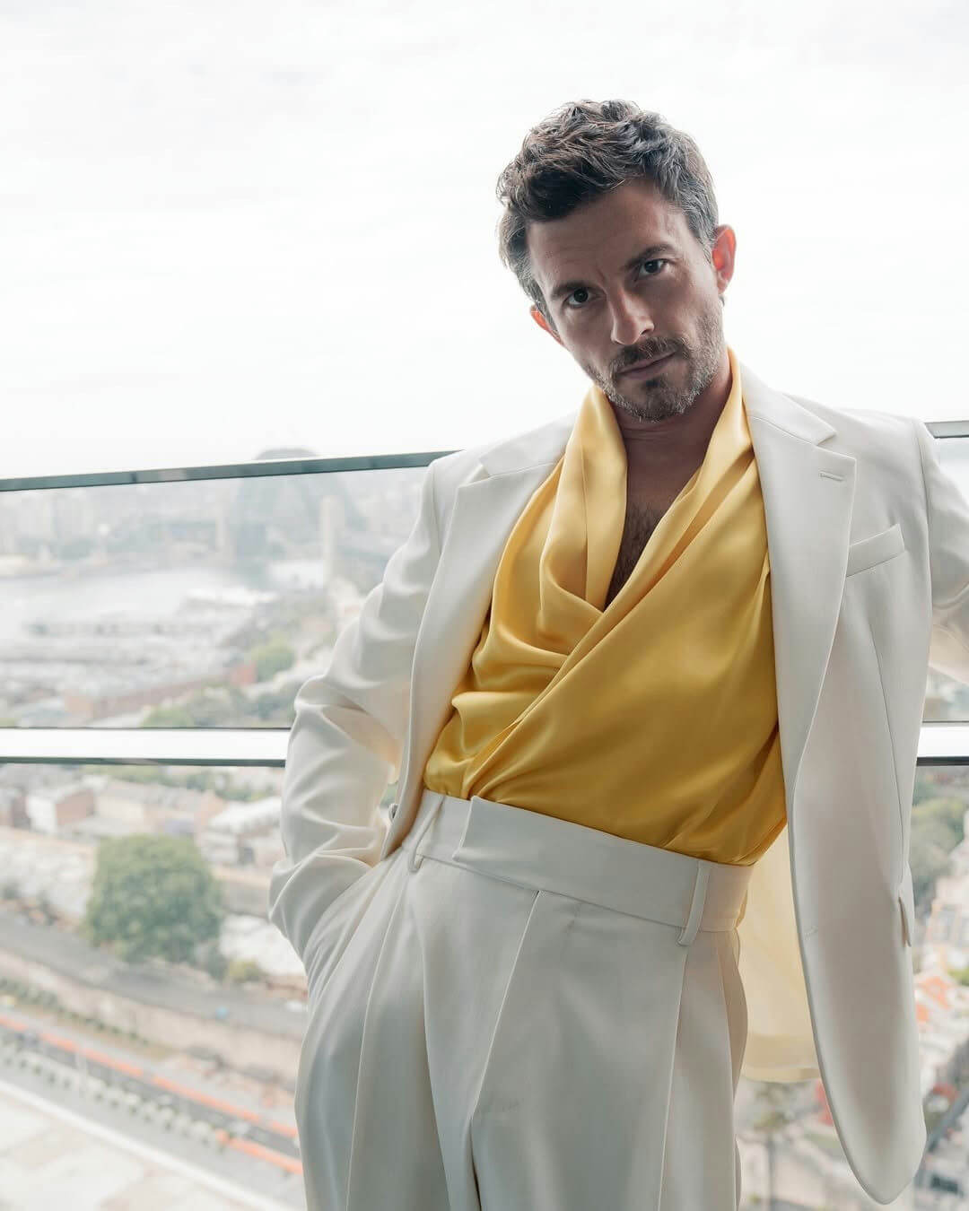 people-one man-A-fashion-A-white suit-B-yellow silk shirt-C-balcony view