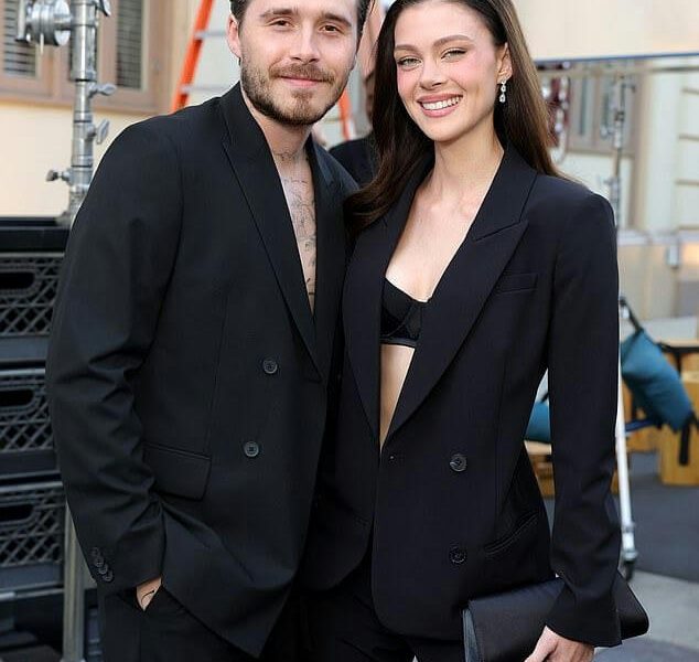 people-Brooklyn Beckham and Nicola Peltz-couple-black suits-smiling-outdoor setting