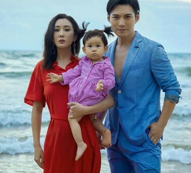 people-3-family portrait-A-beach setting-B-man in blue suit-C-woman in red dress-D-baby in striped dress