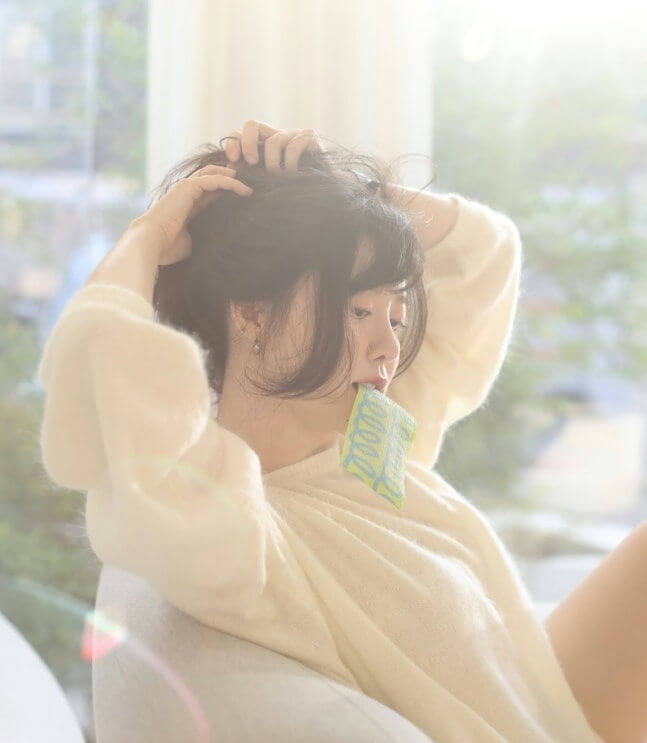 people-Woman-A-messy hair-A-cozy sweater-B-biting object-C