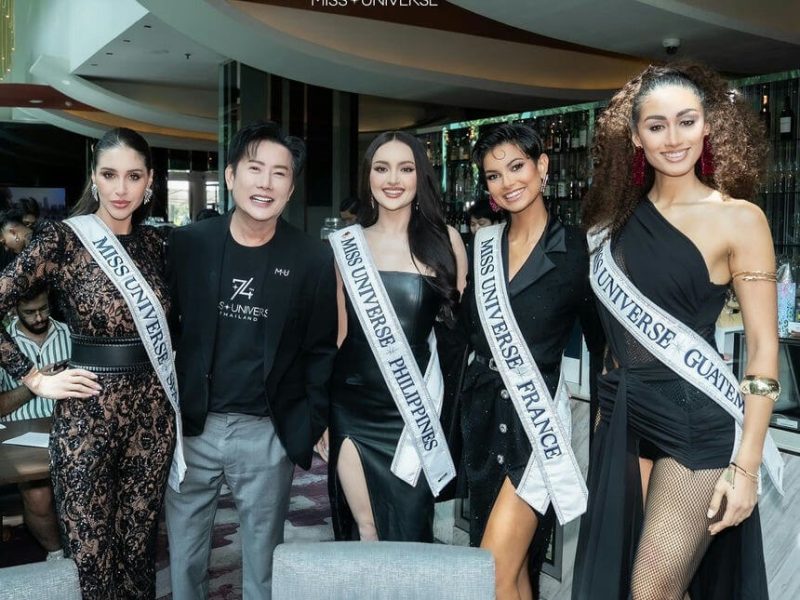 people-Five individuals-A-Miss Universe contestants-A-man in black shirt-B-women wearing sashes-C-black formal attire