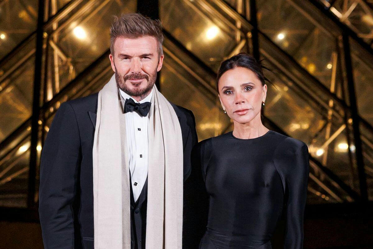 people-David Beckham-A-black tuxedo-A-beige scarf-B-Victoria Beckham-B-black dress-C-Paris Fashion Week
