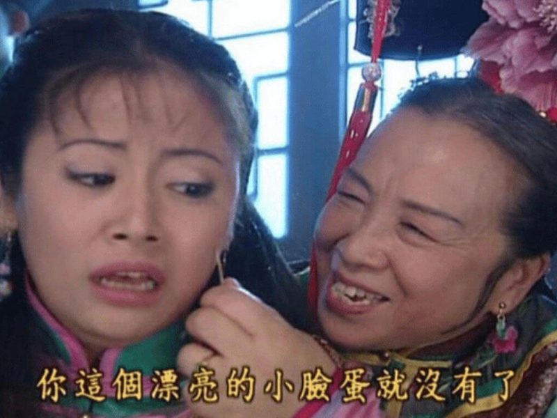 people-Two women-A-Chinese drama screenshot-A-Older woman smiling and touching younger woman's ear-B-Younger woman looking distressed-C-Chinese subtitles present