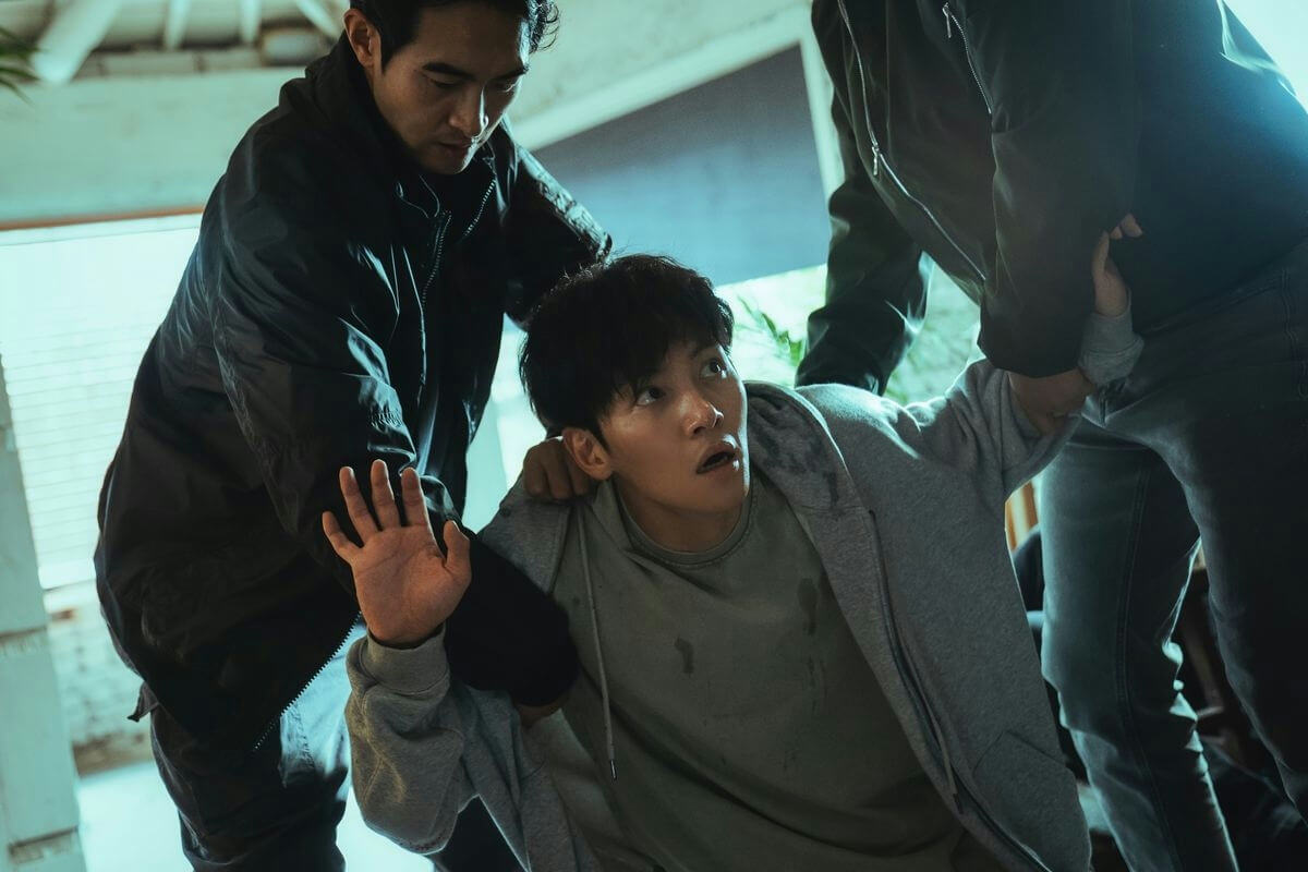 people-2 men restraining 1 man-distress-man in grey hoodie-man in black jacket-hostage situation