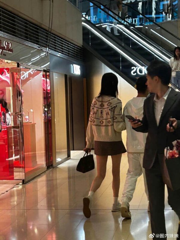 people-woman in patterned sweater and short skirt-woman in patterned sweater and short skirt-man in suit-man in white outfit