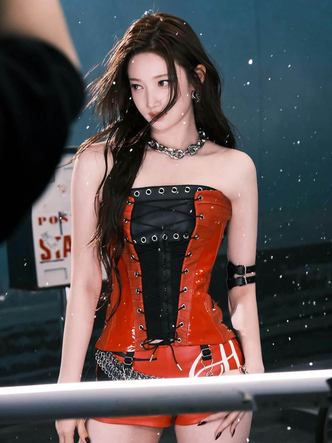 people-woman-A-long dark hair-A-red and black corset-A-chunky silver necklace-A-snow or glitter effect