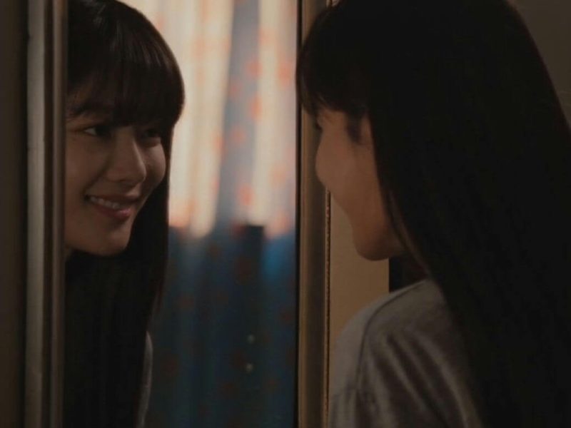people-Woman looking at reflection-A-Mirror-A-Smiling-B-Dark hair-C