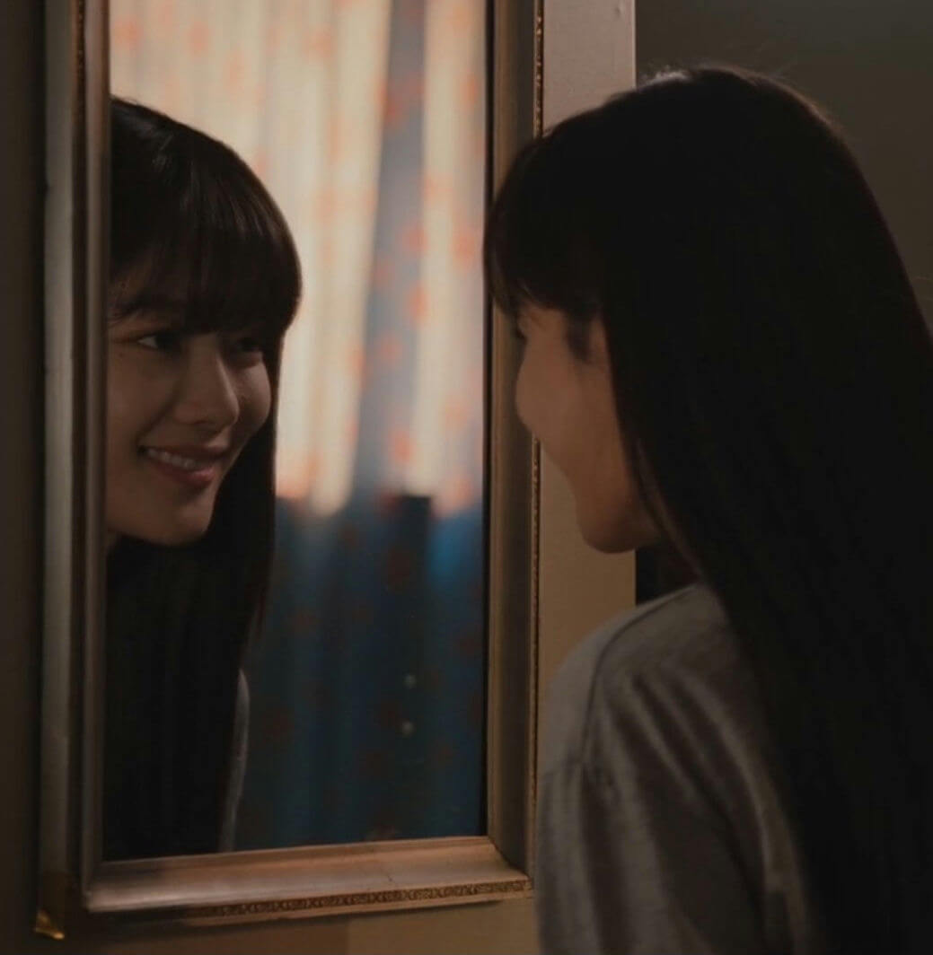 people-Woman looking at reflection-A-Mirror-A-Smiling-B-Dark hair-C