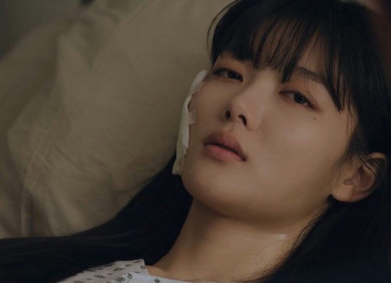 people-woman-lying down-bandaged-hospital gown-dark hair