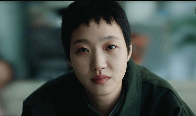 people-woman-short black hair-close-up-sad expression-dark green jacket