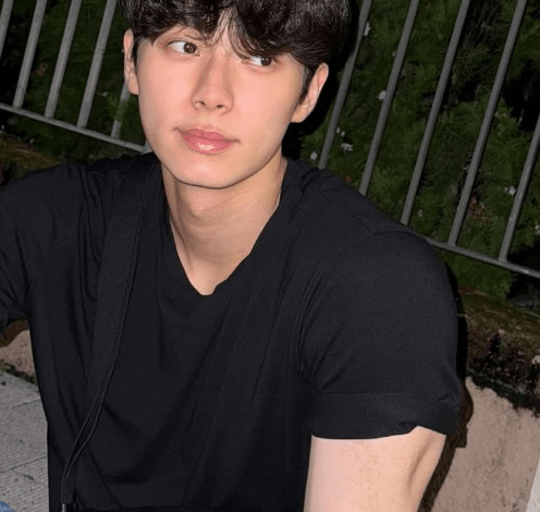 people-man-A-black t-shirt-A-dark hair-A-crossbody bag-A-Saint Laurent logo