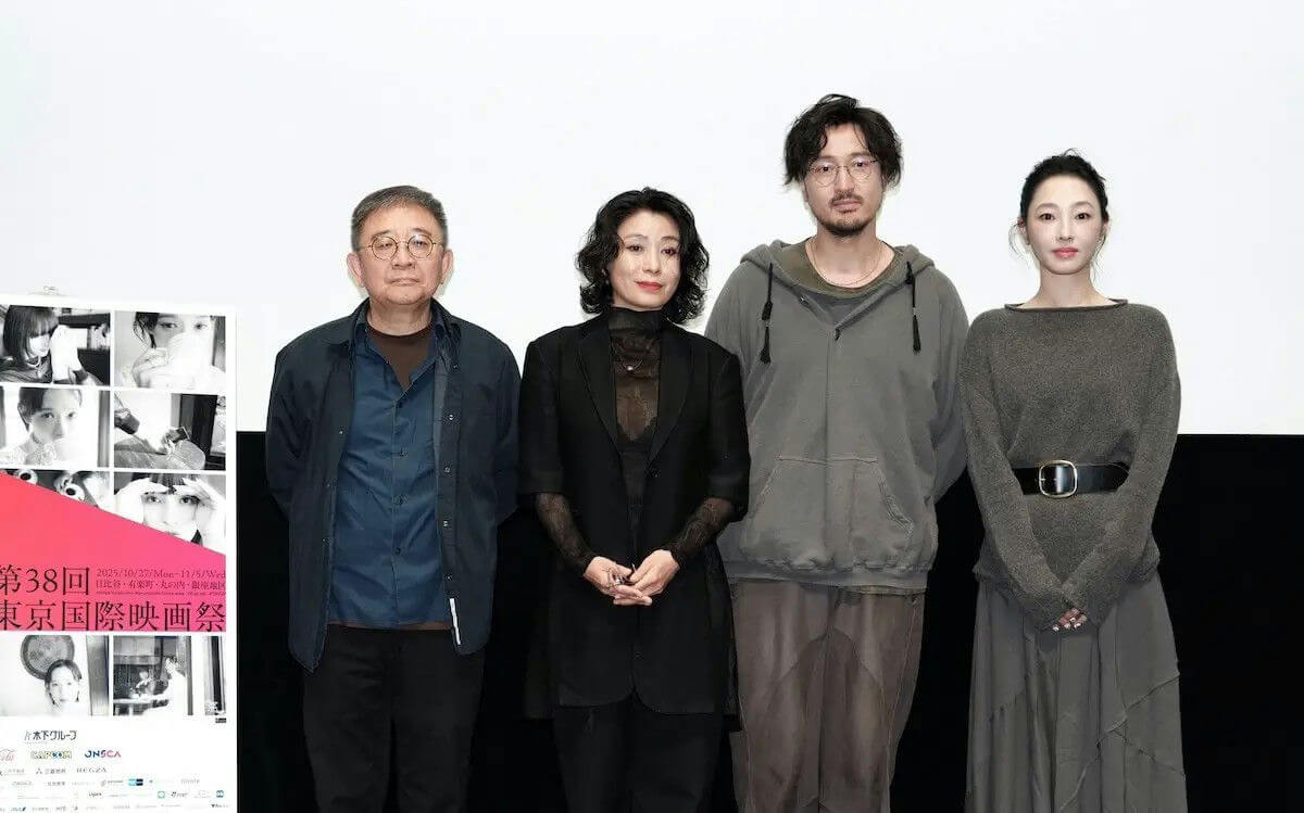 people-four people-A-standing-A-event stage-A-Japanese film festival poster-A-casual/formal attire