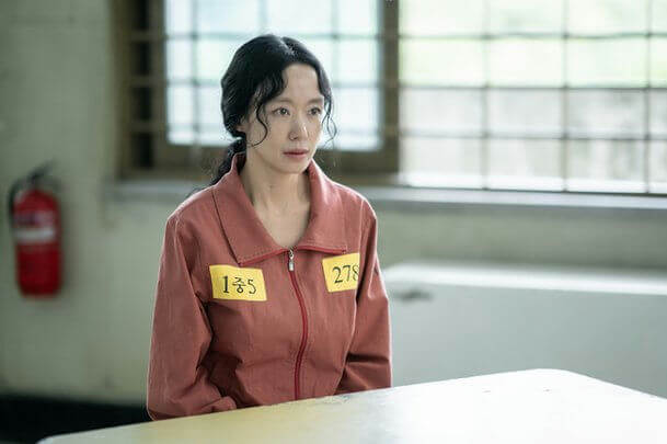 people-woman-A-prison uniform-B-ID tags-C-serious expression