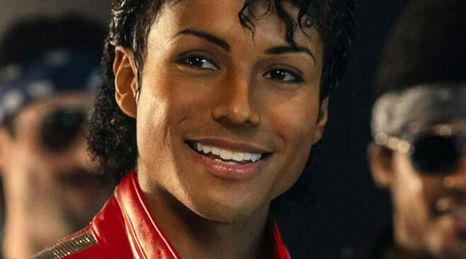 people-A-Michael Jackson impersonator-A-red jacket-A-smiling-A-dark background