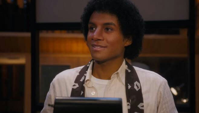 people-young man-smiling-dark curly hair-wearing white shirt-brown patterned scarf