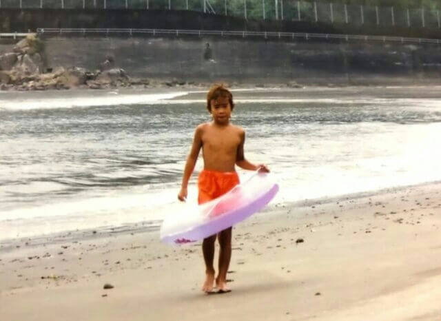 people-A-child-A-boy-A-beach-A-inflatable-toy-A-swimwear-A-sand-A-water-A-seawall