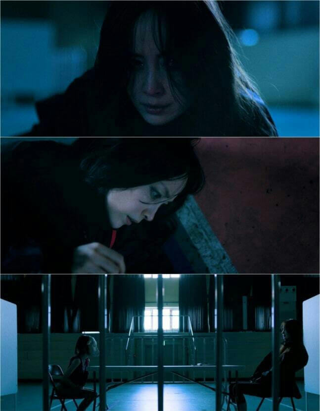 people-one woman crying-A-woman crouching-A-two figures in separate enclosures-B-dark blue lighting-C