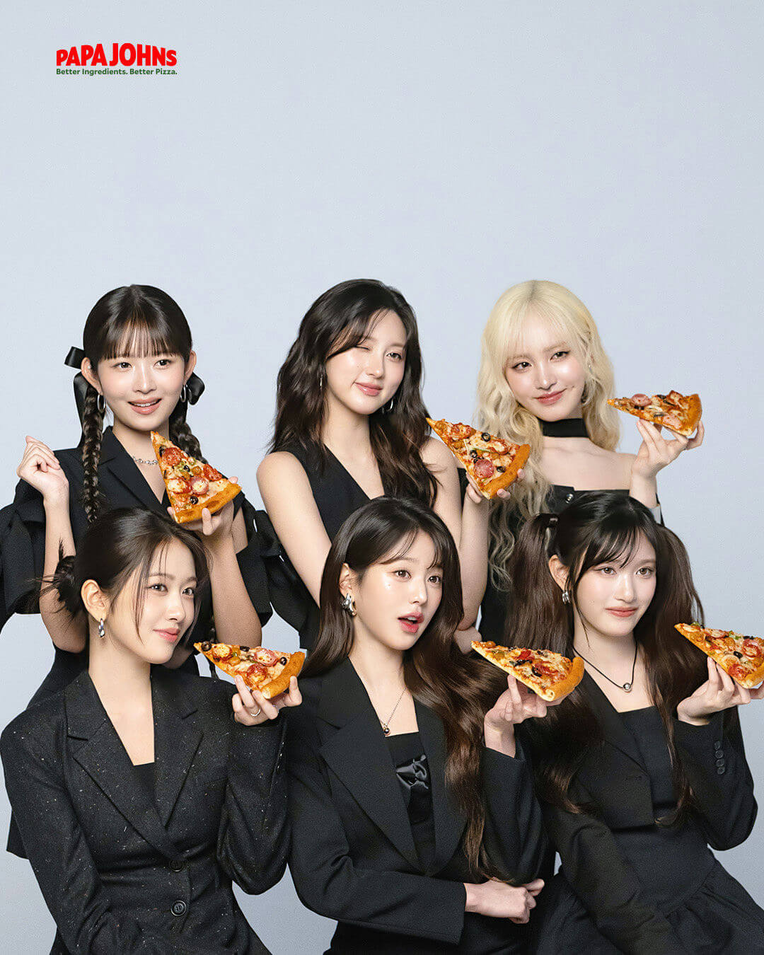 people-six K-pop idols-A-Papa John's pizza-A-all wearing black outfits-B-posing and holding pizza slices-C-studio background