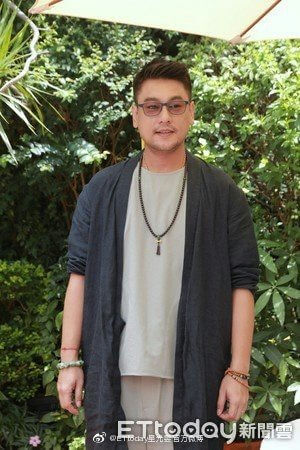 people-A-man-A-glasses-A-dark-cardigan-A-beaded-necklace