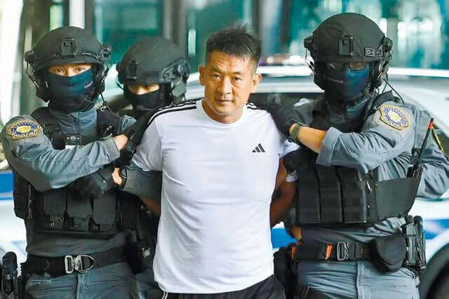 people-man in white shirt being escorted-police officers in tactical gear-arrest-escort