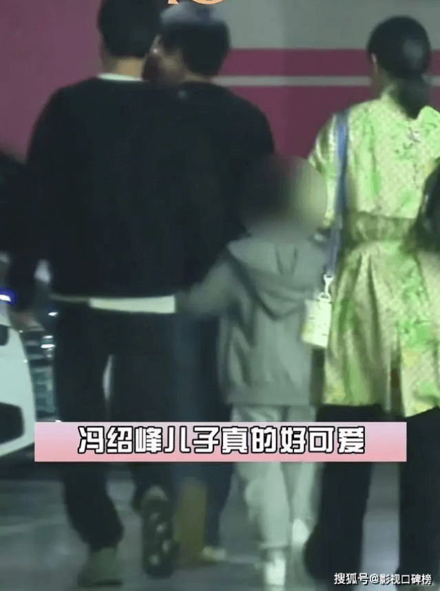 people-two men in black tops and dark pants-A-child in grey hoodie and sweatpants-B-woman in light green patterned top and dark pants-C-street/parking area at night
