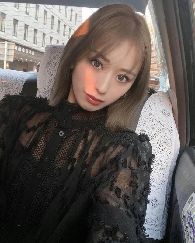 people-woman-A-sitting in car-B-wearing black sheer blouse-C-catching sunlight on face